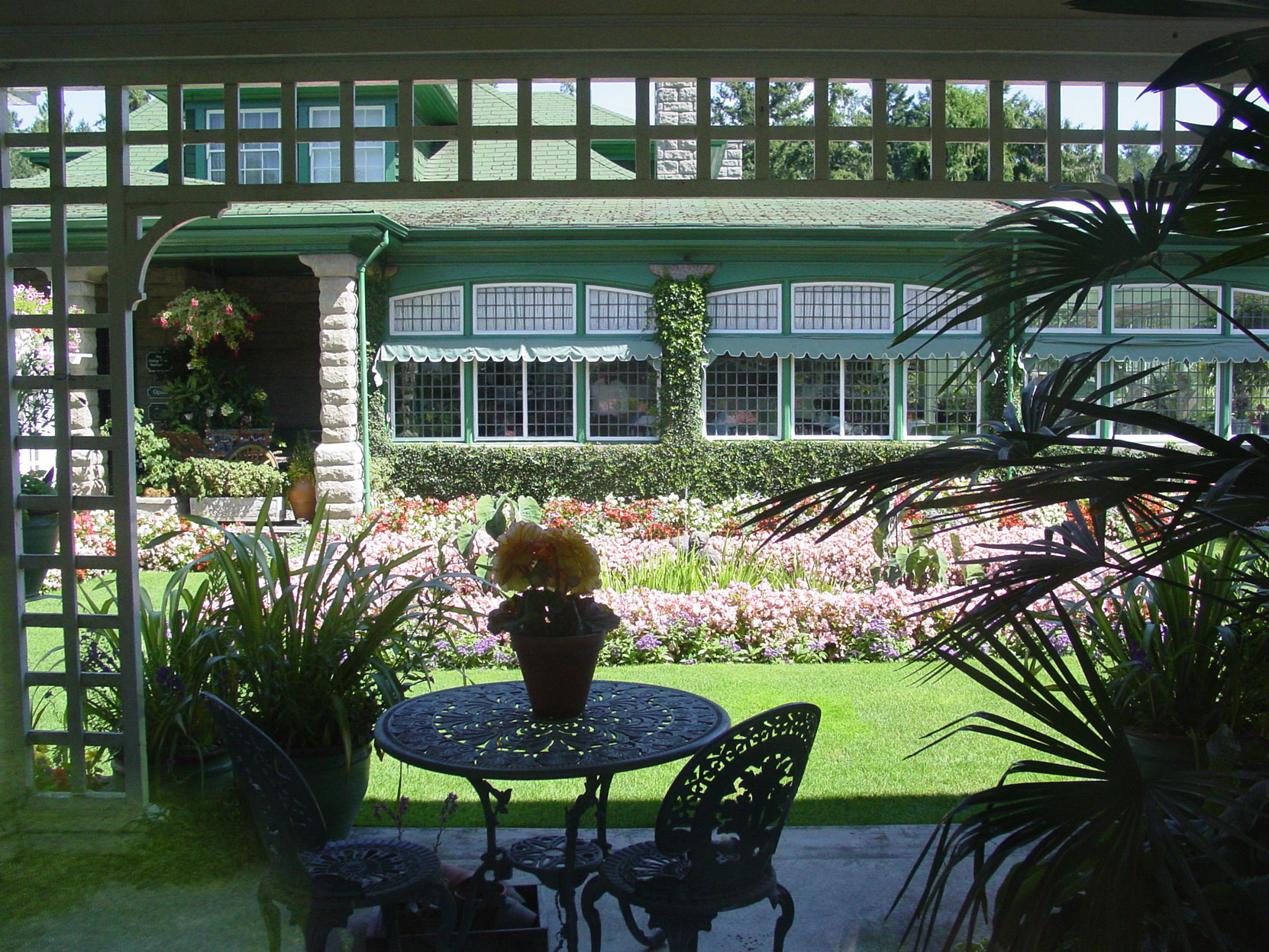 Jennie Butchart's Private Garden, designed and built in 1920-1921 by architect Samuel Maclure, looking toward the Sun Room, designed by Samuel Maclure in 1911 and extended by Samuel Maclure in 1919.This photo was taken from the Sun Room in August (photo by Author)