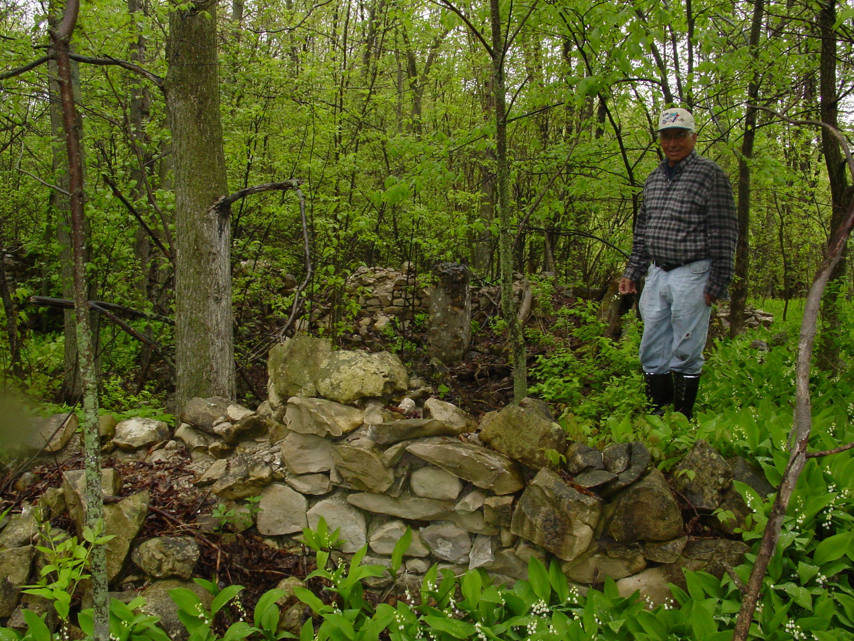 Landowner Murray Noble in what are believed to be the ruins of the Butchart's house at the Shallow Lkae factory site. Ruins of the Owen Sound Portland Cement Company factory, Shallow Lake, Ontario, 2003. (photo by author)