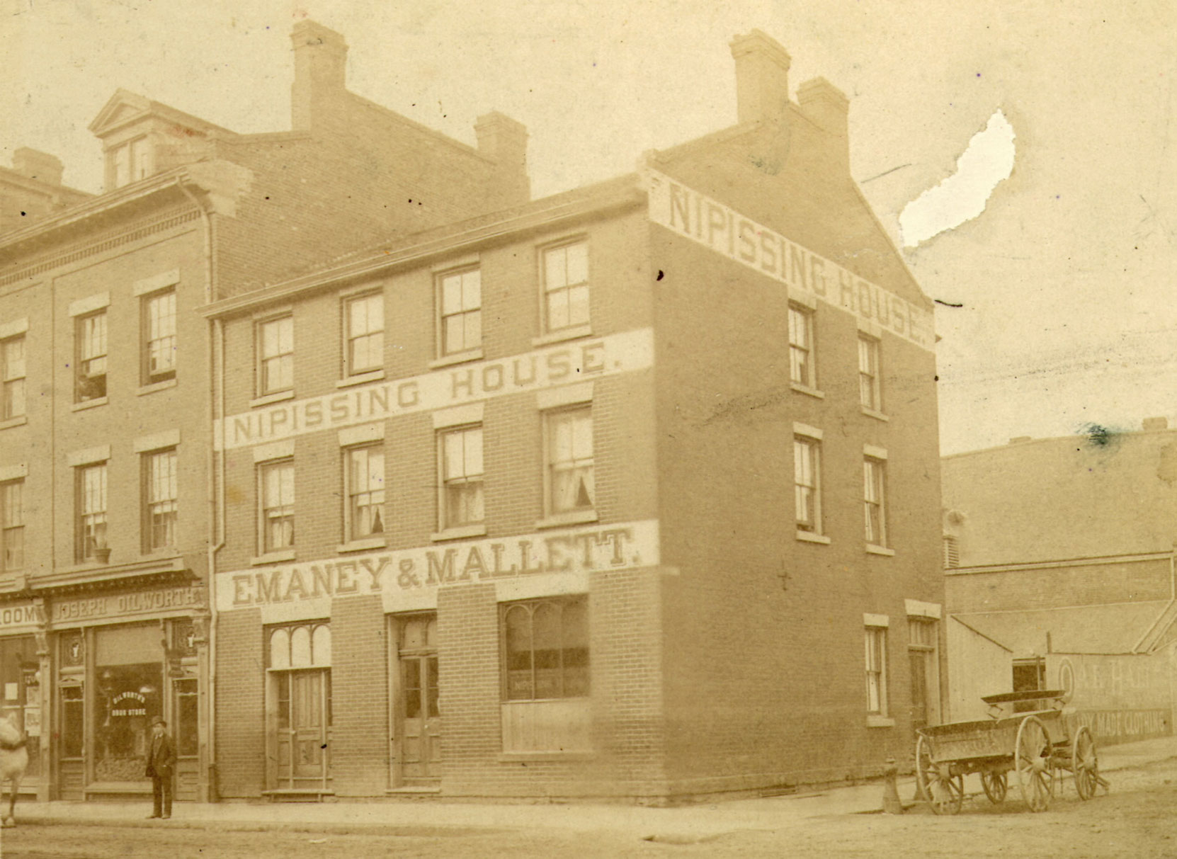 Nipissing House in 1885. It stood on the north west corner of George Street and King Street East in downtown Toronto and was owned by Jennie Butchart's mother, Martha Kennedy. The building partially visible at the right of the photograph might be Martha Kennedy's home at 56 George Street. (Toronto Public Library photo B 11-31a)