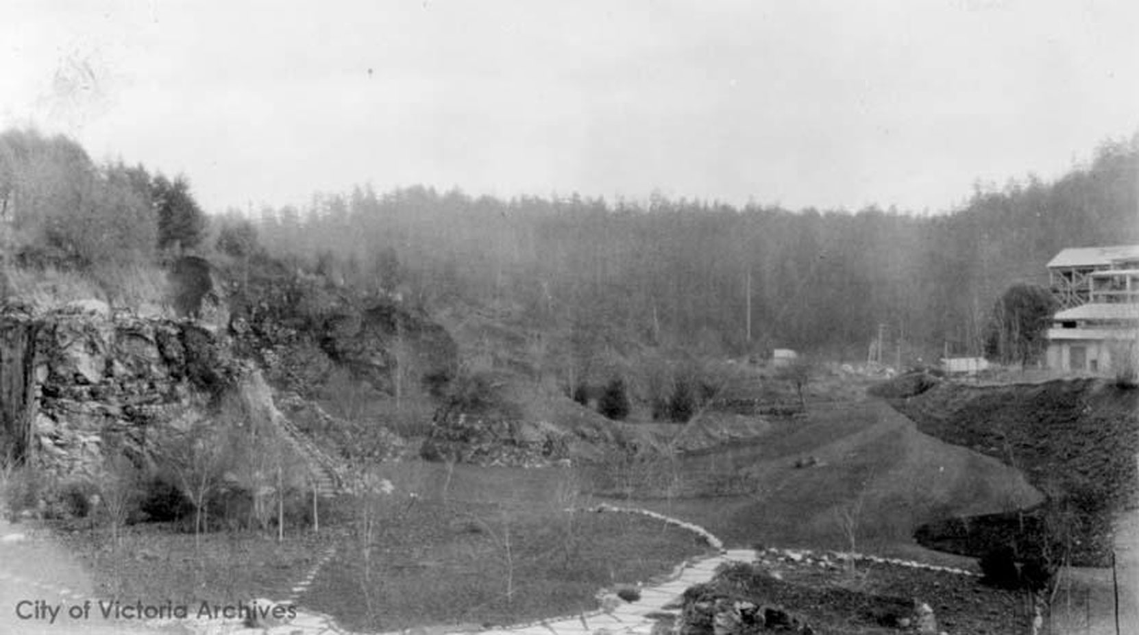 The Vancouver Portland Cement Company plant (right) above the west side of the Sunken Garden and the Mound, circa 1910. This section of the Sunken Garden was designed by Raoul Robillard. (City of Victoria Archives photo M05821)