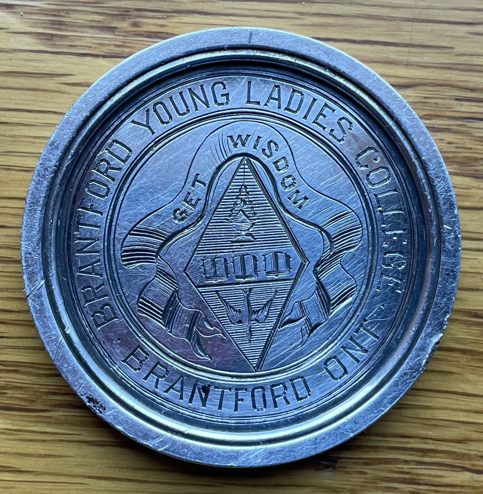 Medallion showing the logo of the Brantford Young Ladies College, Brantford, Ontario. Jennie Kennedy attended this college before marrying Robert Butchart (courtesy of David Pease - private collection, used with permission)